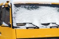 Snow on the windshield of a yellow truck Royalty Free Stock Photo