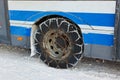 Snow winter chains on tyre of car Royalty Free Stock Photo