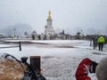 Snow winter day front buckingham palace round about statue fountain street road guard change horses parade London Royalty Free Stock Photo