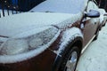 Snow in winter, late in the evening, several cars parked near the house covered with snow Royalty Free Stock Photo