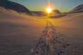 Snow winter in the mountains beyond Northern polar circle, sunset path to horizon