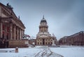 Snow and winter panoramic view of famous Gendarmenmarkt square with Berlin Concert Hall and German Cathedral. Early Royalty Free Stock Photo