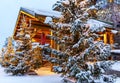 Snow wooden covered buildings in Santa Park