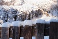 Snow on a wooden fence in winter afternoon outdoors