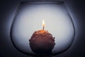 Snowball candle burning inside glass goblet Royalty Free Stock Photo