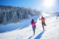 Snowball fight. Winter couple having fun playing in snow outdoors. Young joyful happy multi-racial couple. Royalty Free Stock Photo