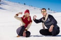 Snowball fight. Winter couple having fun playing in snow outdoors. Young joyful happy multi-racial couple. Royalty Free Stock Photo