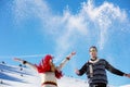 Snowball fight. Winter couple having fun playing in snow outdoors. Young joyful happy multi-racial couple. Royalty Free Stock Photo