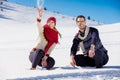 Snowball fight. Winter couple having fun playing in snow outdoors. Young joyful happy multi-racial couple. Royalty Free Stock Photo