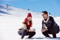 Snowball fight. Winter couple having fun playing in snow outdoors. Young joyful happy multi-racial couple. Royalty Free Stock Photo