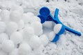 Snowballs formed with a manual ball bead machine. Winter fun. Snow fight tool Royalty Free Stock Photo