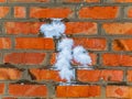 Snowballs thrown into a red brick wall.