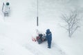Snowblower removes snow,worker cleans the road on the street Royalty Free Stock Photo