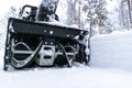 Snowblower at work on a winter day. Removing snow after blizzard snowfall. Clearing the ice. A snow blower is clearing a driveway