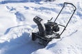 Snowblower at work on a winter day. Snowplow removing snow after blizzard. Clearing the ice. Snow removal machine. Clear driveway