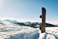 Snowboard With Black And White Strips Standing In Snow With Winter Mountains In Background Royalty Free Stock Photo