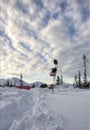 Snowboard in snow-drift in sunset Royalty Free Stock Photo