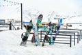 A snowboard stand outside in front of a restaurant in a ski resort. Parking for snowboards and skis