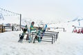 A snowboard stand outside in front of a restaurant in a ski resort. Parking for snowboards and skis