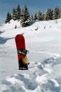 Snowboard stuck in the snow Royalty Free Stock Photo