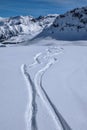 Snowboard tracks in snow above Courchevel