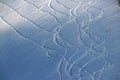 Snowboard tracks on a snowy mountainside on sunset Royalty Free Stock Photo