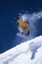 Snowboarder Above Slope With Snow Powder Trailing Behind