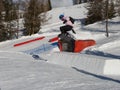 Snowboarder in Action: Jumping in the Mountain Snowpark Royalty Free Stock Photo