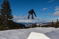 Snowboarder in Action: Jumping in the Mountain Snowpark Royalty Free Stock Photo