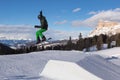 Snowboarder in Action: Jumping in the Mountain Snowpark Royalty Free Stock Photo