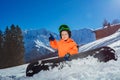 Snowboarder boy point finger and smile on alpine ski track Royalty Free Stock Photo