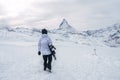 Snowboarder walking towards Matterhorn peak in Zermatt, Switzerland. Royalty Free Stock Photo