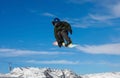 Snowboarder catches big air on a bright sunny day. Livigno, Italy Royalty Free Stock Photo