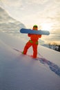 Snowboarder climbing on the top of ski slope Royalty Free Stock Photo