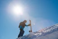 Snowboarder Climbing up with Red Snowboard in the Mountains at Sunny Day. Snowboarding and Winter Sports Royalty Free Stock Photo