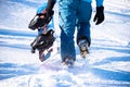 Snowboarder Climbing up with Snowboard in the Mountains at Sunny Day. Snowboarding and Winter Sports Royalty Free Stock Photo