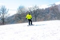 Snowboarder descends a steep slope from a mountain Royalty Free Stock Photo