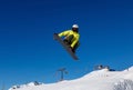 Snowboarder does a jumping trick in the snow park in Livigno, Italy