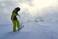 Snowboarder does the trick raises the front of the board.