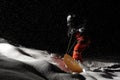 Snowboarder riding on board at night under the snow Royalty Free Stock Photo