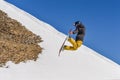 Snowboarder enjoying runs and jumps on spring`s last snow.