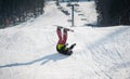 Snowboarder falls on the slopes during the descent Royalty Free Stock Photo