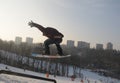 Snowboarder in flight while snowboarding