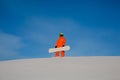 Snowboarder freerider with white snowboard sitting on the top of the ski slope Royalty Free Stock Photo