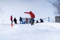 A snowboarder gets air off a jump in a terrain park