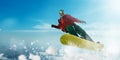 Snowboarder in glasses makes a jump, winter sport Royalty Free Stock Photo