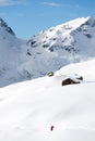 Snowboarder goes downhill over a snowy mountain landscape. Royalty Free Stock Photo