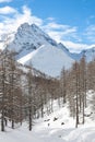 Snowboarder goes downhill over a snowy mountain landscape Royalty Free Stock Photo