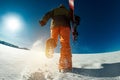 Snowboarder goes uphill backcountry skiing