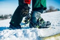 Snowboarder hand fastens snowboard fastening